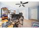 Bedroom features a desk with computers, a ceiling fan, and carpeted floors at 13722 Lakemont Dr, Hudson, FL 34669