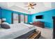 Bright bedroom with blue walls, carpeted floor, and a unique pallet bed frame at 13722 Lakemont Dr, Hudson, FL 34669