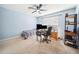Bedroom with a ceiling fan, a window, and a desk with computers at 13722 Lakemont Dr, Hudson, FL 34669