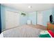 Light blue bedroom featuring double door closet and light colored carpeting at 13722 Lakemont Dr, Hudson, FL 34669