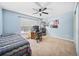 Bedroom with a ceiling fan, a window, and a desk with a computer at 13722 Lakemont Dr, Hudson, FL 34669