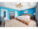 Bright bedroom with blue walls, carpeted floor, a ceiling fan, and a unique pallet bed frame at 13722 Lakemont Dr, Hudson, FL 34669