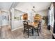 Elegant dining room with wood table, seating for six, and view into a well-lit kitchen at 13722 Lakemont Dr, Hudson, FL 34669