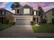 Two-story home featuring a two-car garage, well-maintained lawn, and lovely curb appeal at 13722 Lakemont Dr, Hudson, FL 34669