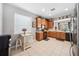 Cozy kitchen featuring wood cabinets, black appliances, and a small table by a window for natural light at 13722 Lakemont Dr, Hudson, FL 34669
