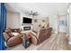 Bright and airy living room with hardwood floors, a modern fireplace, and comfortable seating at 13722 Lakemont Dr, Hudson, FL 34669