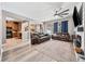 Open-concept living room with hardwood floors, a ceiling fan, and comfortable leather sofas at 13722 Lakemont Dr, Hudson, FL 34669