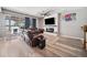 Cozy living room featuring hardwood floors, a fireplace, and sliding glass doors to the backyard at 13722 Lakemont Dr, Hudson, FL 34669