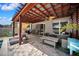 Relaxing backyard patio features a pergola, ceiling fan, outdoor furniture, and brick pavers at 13722 Lakemont Dr, Hudson, FL 34669