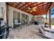 Inviting outdoor patio features a pergola, ceiling fan, stylish furniture, and a tiled floor at 13722 Lakemont Dr, Hudson, FL 34669