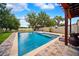 Beautiful backyard pool with a stone surround, a built-in spa, and lush landscaping creating a serene outdoor oasis at 13722 Lakemont Dr, Hudson, FL 34669