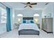 Sunlit bedroom showcasing a large window, neutral walls, and a ceiling fan, providing a relaxing and stylish retreat at 1411 Tessano Pl, Palm Harbor, FL 34683