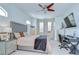 Comfortable bedroom featuring neutral walls, a ceiling fan, desk, and large windows providing natural light and workspace at 1411 Tessano Pl, Palm Harbor, FL 34683