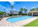 Refreshing community pool with clear blue water, lounge chairs, and a shaded cabana, surrounded by palm trees at 1411 Tessano Pl, Palm Harbor, FL 34683