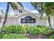 Entrance sign for Villas of San Marino at Palm Harbor surrounded by lush tropical foliage at 1411 Tessano Pl, Palm Harbor, FL 34683