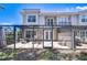 Exterior view of a two-story home with a screened patio and well-maintained backyard and outdoor seating at 1411 Tessano Pl, Palm Harbor, FL 34683