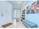 Bright and inviting foyer with tile flooring, a modern display shelf, and a comfortable blue bench at 1411 Tessano Pl, Palm Harbor, FL 34683