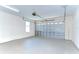 Spacious garage with an overhead door, ample lighting, and clean, painted walls, ready for parking or storage at 1411 Tessano Pl, Palm Harbor, FL 34683