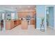Well-lit kitchen featuring stainless steel appliances, light wood cabinetry, and tile flooring at 1411 Tessano Pl, Palm Harbor, FL 34683