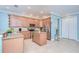 Eat-in kitchen featuring stainless steel appliances, light wood cabinetry, and a center island at 1411 Tessano Pl, Palm Harbor, FL 34683