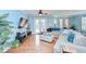 Open-concept living room with wood floors, a large sectional sofa, and French doors to the outdoor space at 1411 Tessano Pl, Palm Harbor, FL 34683