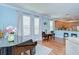 Bright living room with piano, dining table and chairs, light blue walls, and hardwood floors at 1411 Tessano Pl, Palm Harbor, FL 34683