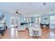 Spacious living room with light blue walls, wood floors, large sectional sofa, and access to the patio at 1411 Tessano Pl, Palm Harbor, FL 34683
