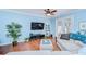 Inviting living room featuring hardwood floors, a ceiling fan, and stylish furnishings for comfortable living at 1411 Tessano Pl, Palm Harbor, FL 34683