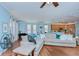 Open-concept living room featuring light blue walls, hardwood floors, sectional sofa, and view of the kitchen at 1411 Tessano Pl, Palm Harbor, FL 34683