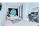 Bright living area featuring white plank flooring, a cozy couch, and a functional home office setup at 1411 Tessano Pl, Palm Harbor, FL 34683