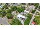 Aerial shot of a cozy home with a bright white roof and small landscaped area in a neighborhood at 1416 55Th N Ave, St Petersburg, FL 33703