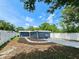 Landscaped backyard featuring a white fence, lush lawn, and a recently painted blue exterior at 1416 55Th N Ave, St Petersburg, FL 33703