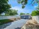 Backyard with white vinyl fence, mulch accents, and blue paint on house at 1416 55Th N Ave, St Petersburg, FL 33703