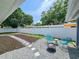 The backyard offers a fire pit with chairs, with views of the grassy area behind the fence at 1416 55Th N Ave, St Petersburg, FL 33703