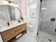 Modern bathroom featuring a double sink vanity, sleek fixtures, and a glass-enclosed shower at 1416 55Th N Ave, St Petersburg, FL 33703