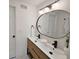 Stylish bathroom featuring a double sink vanity, sleek fixtures, and a modern oval mirror at 1416 55Th N Ave, St Petersburg, FL 33703