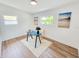 The bedroom could double as an office space, and features laminated wood flooring and white walls at 1416 55Th N Ave, St Petersburg, FL 33703