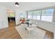 Bright dining area with contemporary furniture, large windows, and wood flooring at 1416 55Th N Ave, St Petersburg, FL 33703