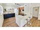 Modern kitchen with stainless steel appliances, hardwood floors, and a stylish island with bar seating at 1416 55Th N Ave, St Petersburg, FL 33703