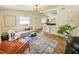 Bright living room with modern lighting, open to the kitchen with counter seating and stylish decor at 1416 55Th N Ave, St Petersburg, FL 33703