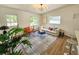 Light-filled living room with views to the entry, stylish furnishings, and hardwood floors at 1416 55Th N Ave, St Petersburg, FL 33703