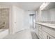 Bathroom featuring double vanity with granite countertop and tiled shower-tub combo at 16433 66Th E Ln, Parrish, FL 34219