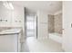 Bathroom featuring double vanity with granite countertop and tiled shower-tub at 16433 66Th E Ln, Parrish, FL 34219