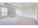 Bright bedroom features large windows, plush carpeting, and a tray ceiling at 16433 66Th E Ln, Parrish, FL 34219