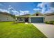 Charming single-story home featuring a manicured lawn and a two-car garage at 16433 66Th E Ln, Parrish, FL 34219