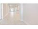 Bright hallway with modern white wood flooring leads to various rooms in this house at 16433 66Th E Ln, Parrish, FL 34219