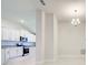 Open-concept kitchen and living area featuring sleek white cabinets and recessed lighting at 16433 66Th E Ln, Parrish, FL 34219