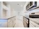 Kitchen featuring stainless steel appliances and granite countertops, leading to the living area at 16433 66Th E Ln, Parrish, FL 34219