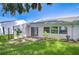 Backyard of house featuring a small patio area, and tropical landscaping at 1655 S Highland Ave # B118, Clearwater, FL 33756