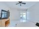 Spacious bedroom featuring tile floors, sliding glass doors to patio, and ceiling fan at 1655 S Highland Ave # B118, Clearwater, FL 33756
